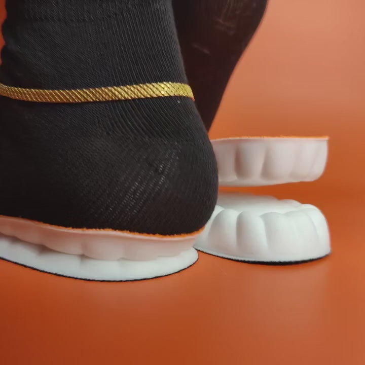 Solerivex insoles: a foot in a black sock steps onto a pair of cushioned insoles